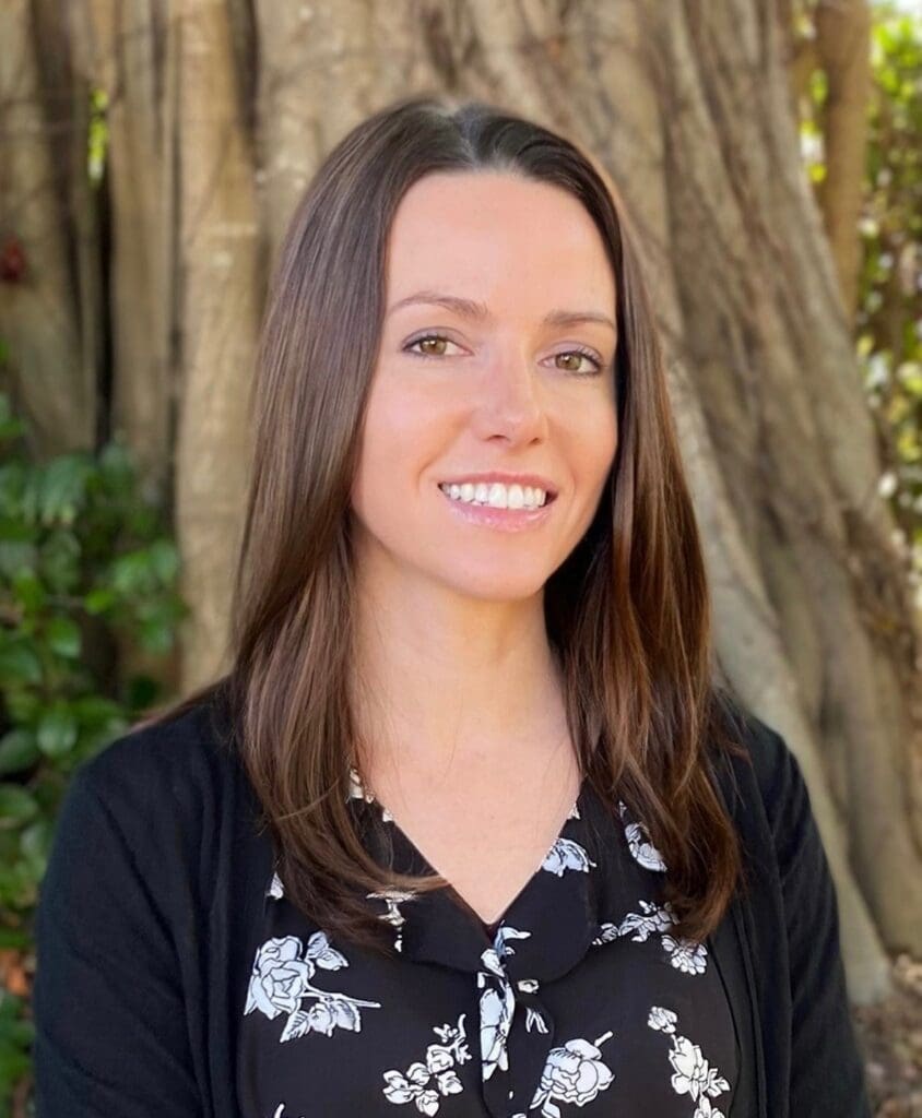 Smiling woman in floral blouse outdoors