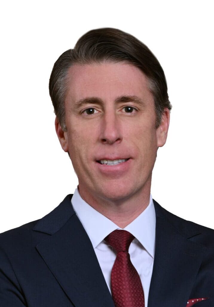 Man in navy suit and red tie